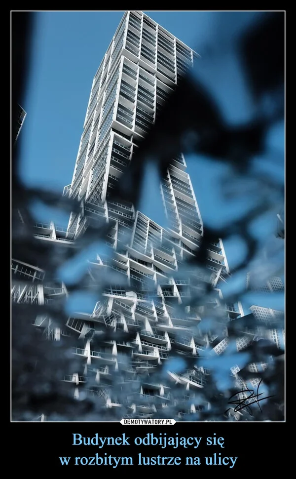 Budynek odbijający się w rozbitym lustrze na ulicy